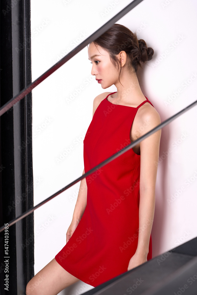 Fototapeta premium 赤いドレスを着た若いアジア女性のスタイリッシュなファッションポートレート