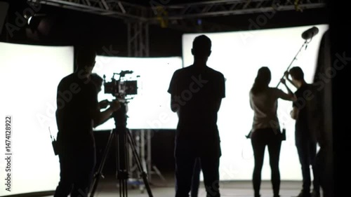 Behind the scene in a studio of video production 4k animation. the scenes of silhouette people working in big production studio setting camera and lighting for shooting online video