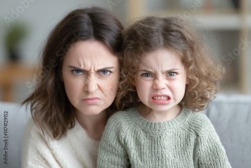 An angry parent is struggling to get through to her defiant kid, who is ignoring her demands for discipline and obedience, highlighting their family conflict
