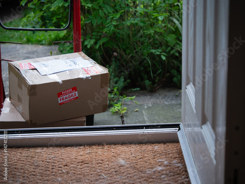 Delivery of cardboard boxes and trolley cart outside of home front door