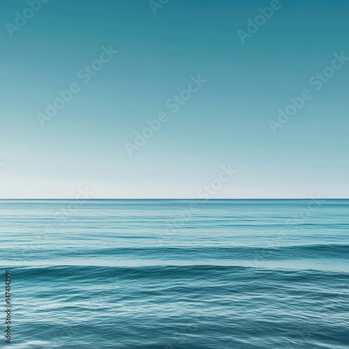 Wallpaper Mural Calm ocean horizon.  A tranquil view of the sea meeting a clear sky.  The water is smooth and slightly rippled, with a soft, pastel blue tone Torontodigital.ca