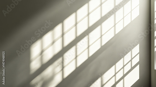 Light and shadow patterns cast by a window on a wall