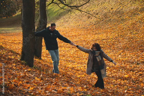 couple holding hands on a walk in autumn