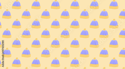 Seamless blue knit beanies background, winter pattern with pom-poms for fabrics and seasonal decoration