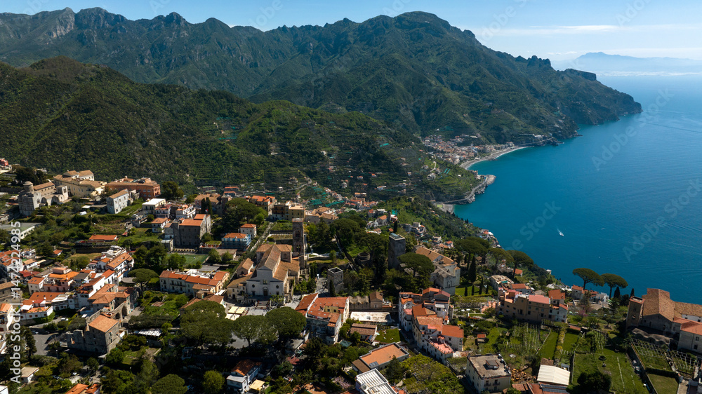 Fototapeta premium Aerial view of the cathedral of Santa Maria Assunta and San Pantaleone in the main square of Ravello. This church is located in the Amalfi Coast, Campania, Italy. In background are Maiori and Minori.