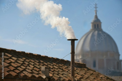 White smoke rises from the chapel chimney, indicating the successful election of a new pope during the papal conclave.
