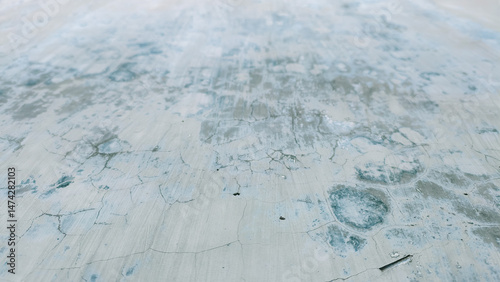 Abstract weathered concrete surface with intricate crack patterns, a backdrop