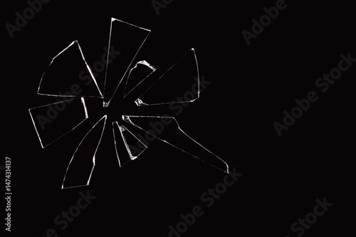 shards of broken glass pane isolated on black background