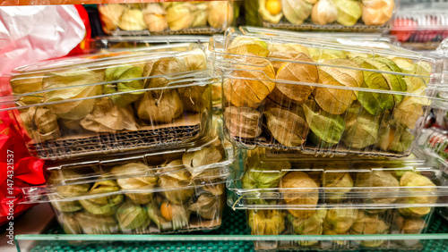 Stacked physalis fruit boxes, an exotic produce display in a supermarket