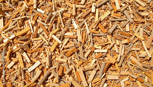 Wood chips as mulch, abundant texture, large pile of wood chips on bright background