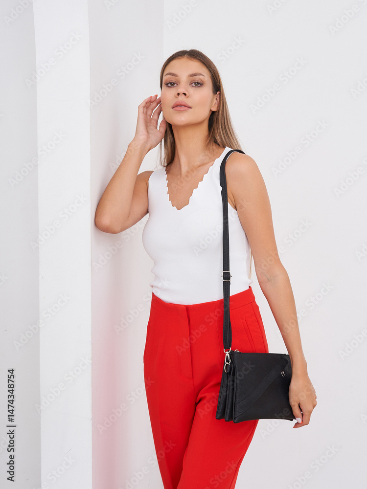 Model Poses in Stylish Outfit Against a Minimalist Background in Bright Setting Model Poses in Stylish Outfit Against a Minimalist Background in Bright Setting