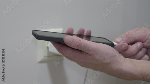 charging a smartphone, close-up of hands connecting cable to charge smartphone, fast charging, smartphone accessories