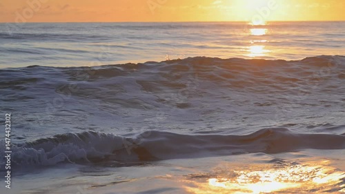 Golden sunrise on tropical beach, waves crashing on shore, island paradise holiday vacation, Queensland Australia