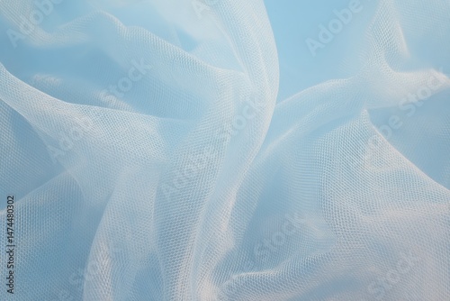 Beautiful lightweight baby blue tulle fabric showcasing soft textures and delicate drapes perfect for crafts and fashion design