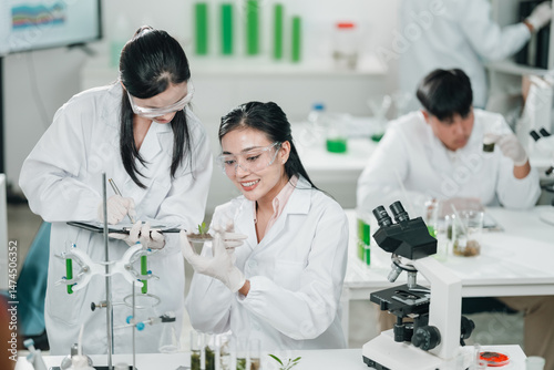 Scientists examining plant ...
