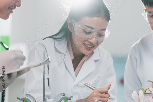 Scientists examining plant ...