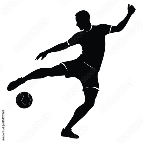 Silhouette shows the male player kicking the soccer ball high while raising his arm