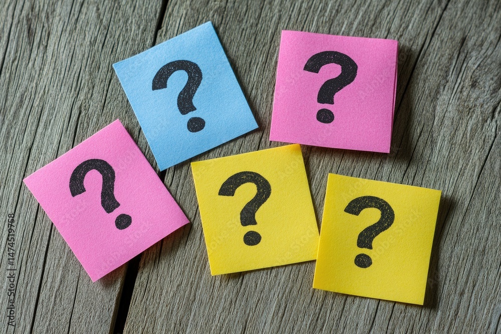 Colorful sticky notes with question marks on a wooden surface (1) Colorful sticky notes with question marks on a wooden surface (1)