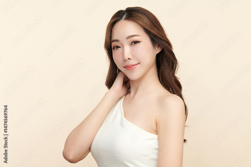 A beautiful young Asian woman with clean, fresh skin against a beige background. Skincare, facial treatment, cosmetology, beauty, and spa. An elegant portrait of an Asian woman. A beautiful young Asian woman with clean, fresh skin against a beige background. Skincare, facial treatment, cosmetology, beauty, and spa. An elegant portrait of an Asian woman.