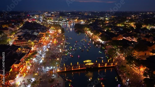 Aerial view of Hoi An old town or Hoian ancient town in evening. Royalty high-quality free stock footage top of Hoai river and boat tour night traffic. One of the most popular touristic destination