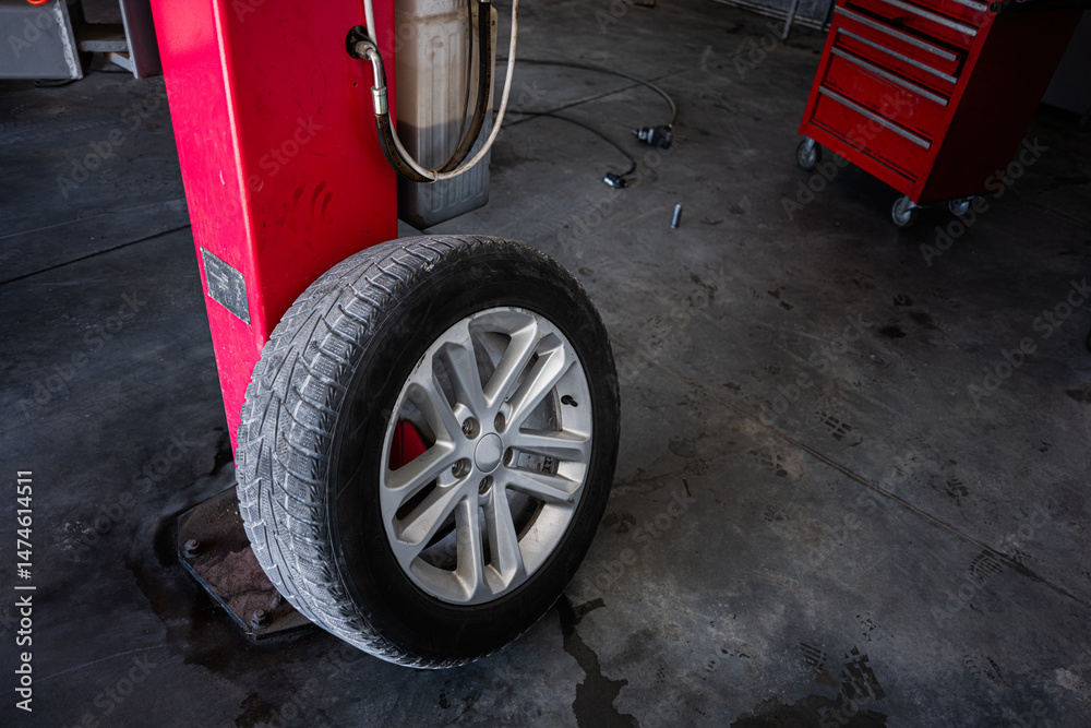 Fototapeta premium Mechanic shop interior with car tire and repair equipment displayed