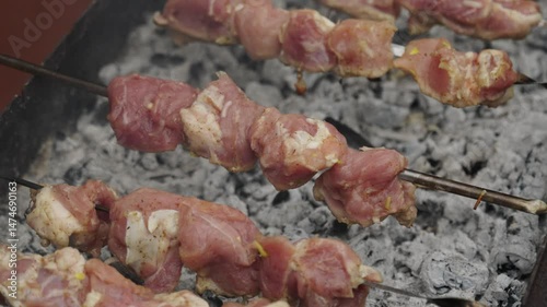 Raw beef pieces skew on metal barbeque close up. Cooking at home. Meat preparation on heat.