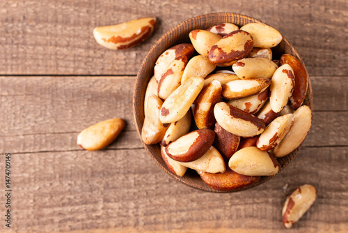 Brazil nuts in a wooden bowl. Healthy fats concept. 