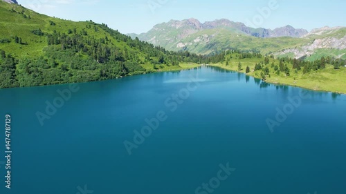 Aerial sunny day on turquoise Engstlensee lake on Switzerland. Travel destination and popular trail.