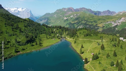 Aerial sunny day on turquoise Engstlensee lake on Switzerland. Travel destination and popular trail.