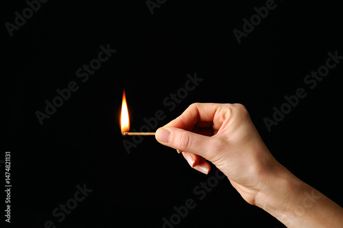 Lit match against a black background