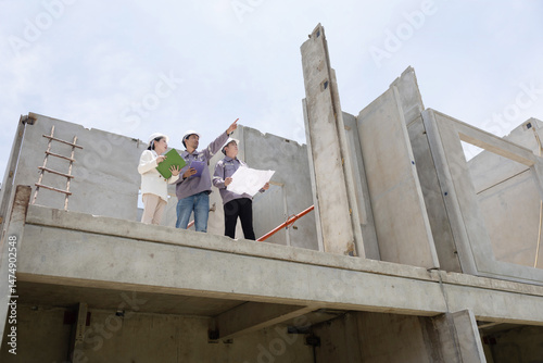 Construction team having a brainstorm on building site