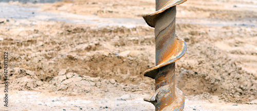 Soil auger, close-up. Construction special equipment. Repair work. Construction activity at a construction site. Close-up of drilling equipment. Geotechnical drilling