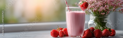 Fresh strawberry protein shake in a glass with berries on the table
