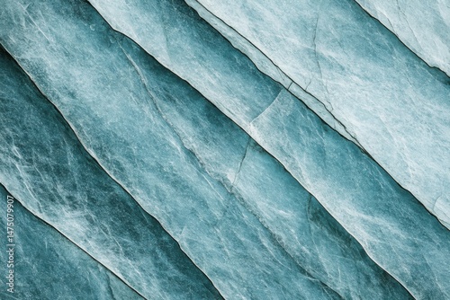 Abstract close up of blue slate rock texture showing diagonal layers and natural cracks for background or design element