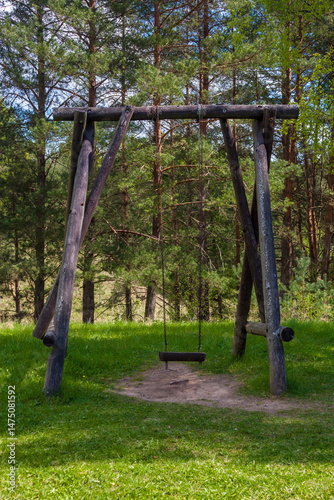 Rustic wooden swing in a forest