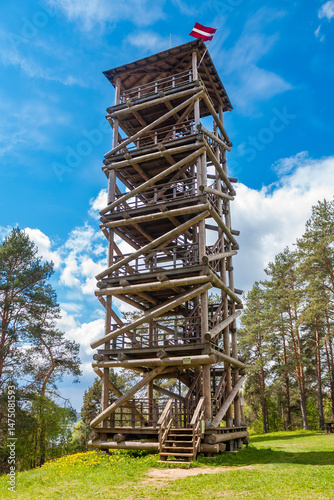 Wooden observation tower with latvian flag on top in Vasargelišķi, Naujene. Nature park Daugavas loki in Latgale, Latvia.