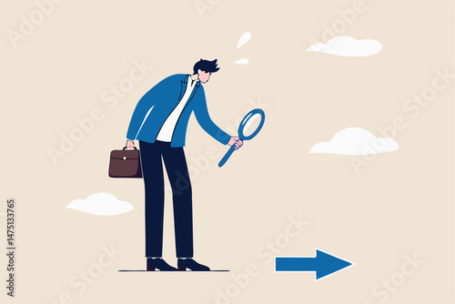 Searching for business direction, strategy or discover business opportunity or solution for work difficulty concept, businessman leader using magnifying glass to discover arrow on the floor.