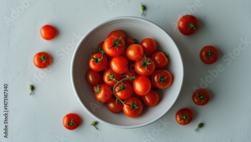 Isolated background featuring a white bowl of cherry tomatoes. Nutritious and fresh. photo
