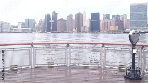 New York City waterfront skyline, Manhattan Midtown buildings, riverfront skyscrapers by East river. Waterside cityscape, tower viewer, Gantry Plaza. Long Island, Queens. United States tourism. Rainy.