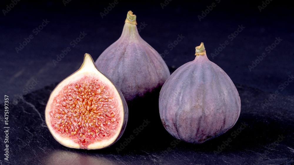 Fototapeta premium Fresh cheese and figs on a black table