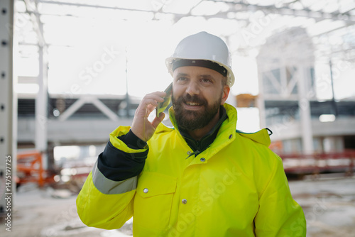 Slika na platnu Portrait of construction foreman making phone call in modern building site