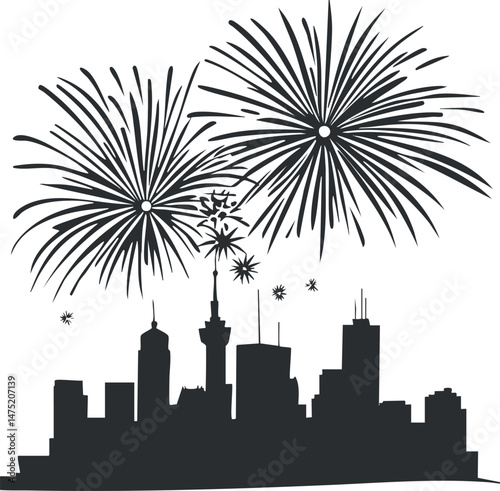 Black silhouette of a city skyline with fireworks exploding in the night sky above during a celebration event.