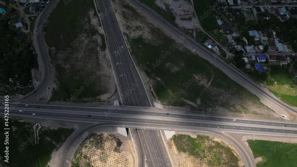 The road is on the outskirts of the city, along villages and houses. The view from the drone. The road is on the outskirts of the city, along villages and houses. The view from the drone.