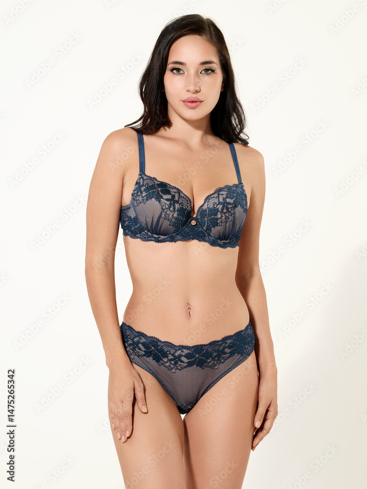 Fototapeta premium Sexy girl model in a beautiful swimsuit, fashion shooting in the studio.