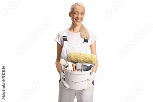 Female house painter holding a bucket with brushes