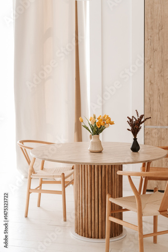 cozy light kitchen with a dining table and chairs