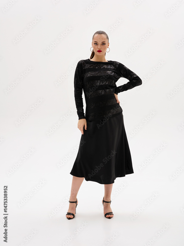 Pregnant girl model in stylish clothes on a colorless background in the studio. Pregnant girl model in stylish clothes on a colorless background in the studio.