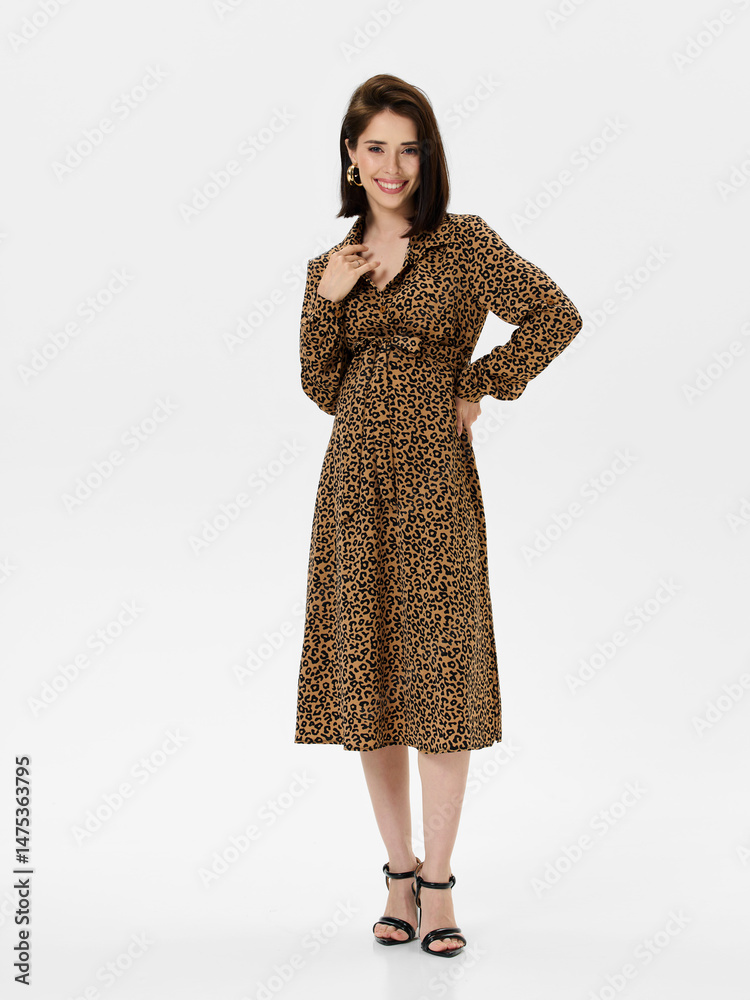 Fototapeta premium Pregnant girl model in stylish clothes on white background in studio.