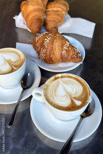 brioche e cappuccino italiano, tray with croissants and italian cappuccino	