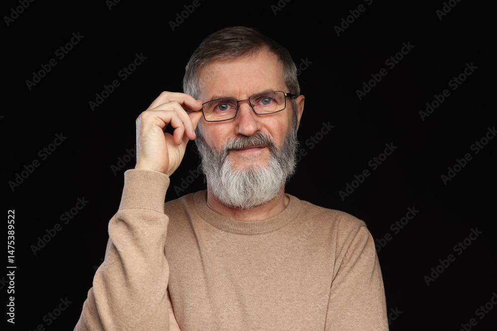 Fototapeta premium Portrait of mature man in glasses on black background